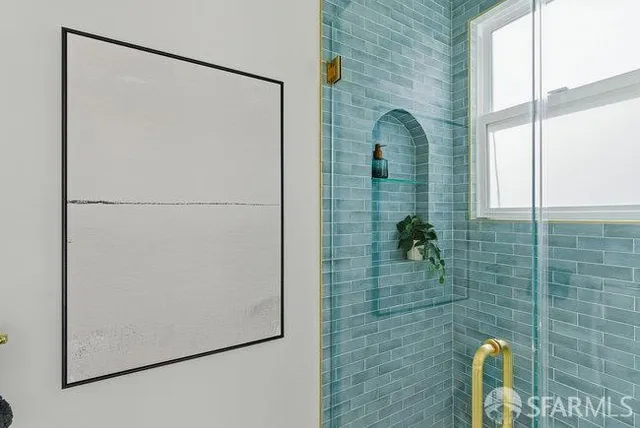 a bedroom with a bed and painting on the wall