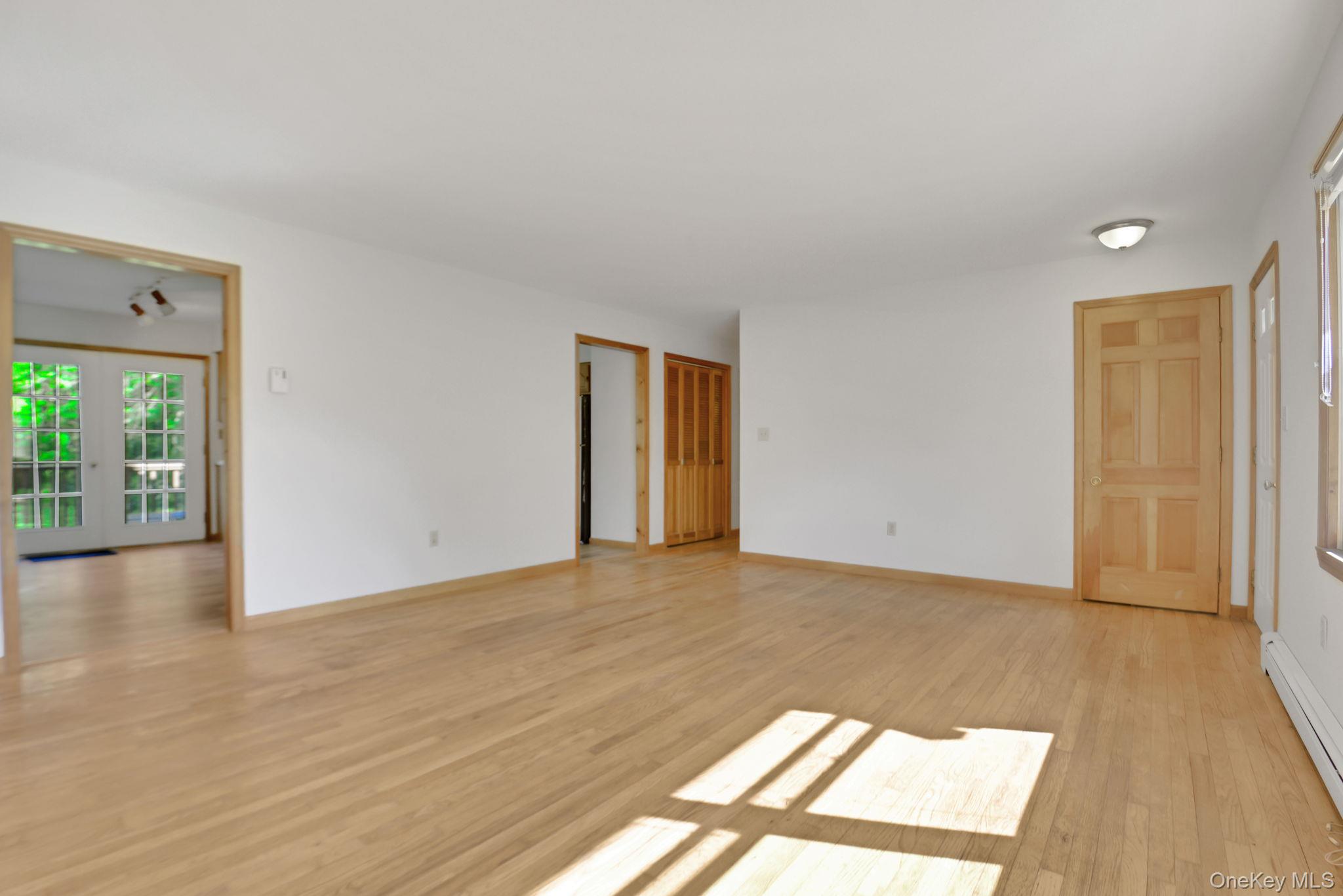 175 Overocker Road Poughkeepsie, NY 12603 - Photo 7 of 29 Spacious room featuring light wood-finish flooring, white walls, and natural wood trim throughout