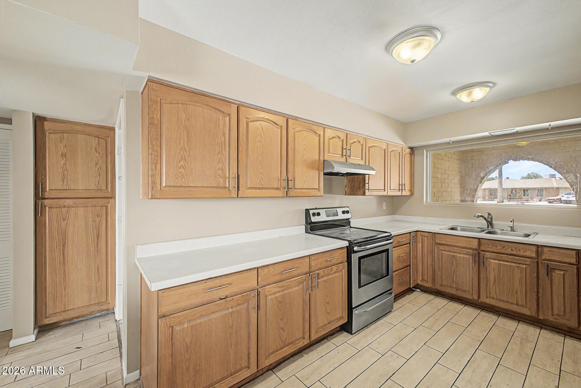 4007 West Mountain View Road Phoenix, AZ 85051 - Photo 13 of 31 a kitchen with a sink stove and cabinets