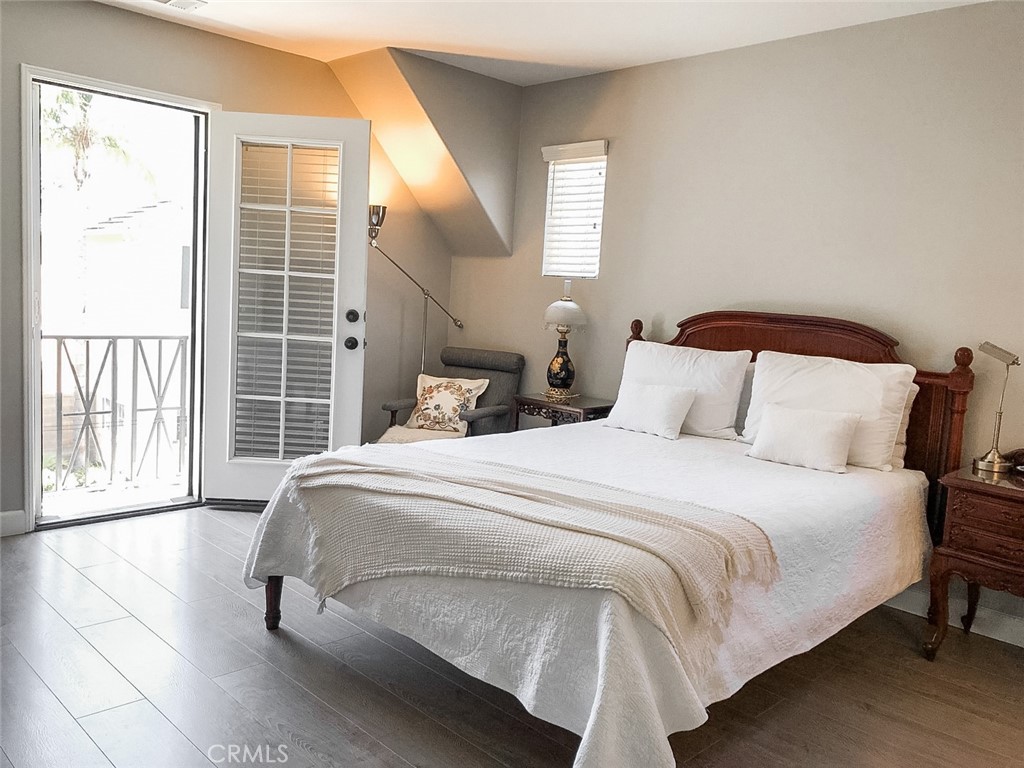 18 Avalon, Unit 5 Irvine, CA 92602 - Photo 6 of 6 a bedroom with a bed and wooden floor