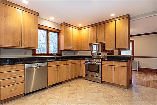 59 Coolidge Road Arlington, MA 02476 - Photo 5 of 22 a kitchen with stainless steel appliances granite countertop a stove a sink and a refrigerator