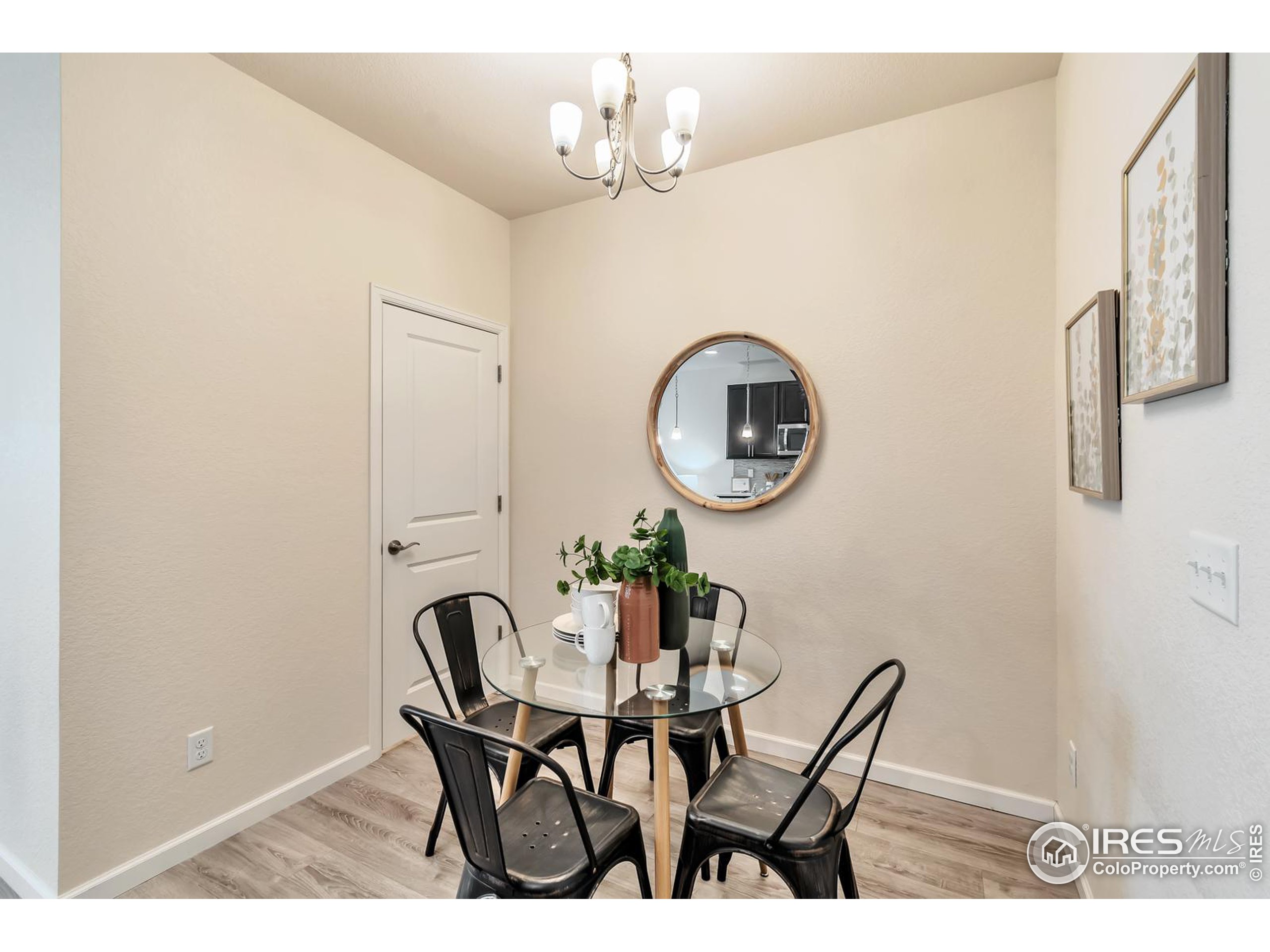 15546 West 64th Loop, Unit C Arvada, CO 80007 - Photo 12 of 27 a view of a dining room with furniture and a chandelier