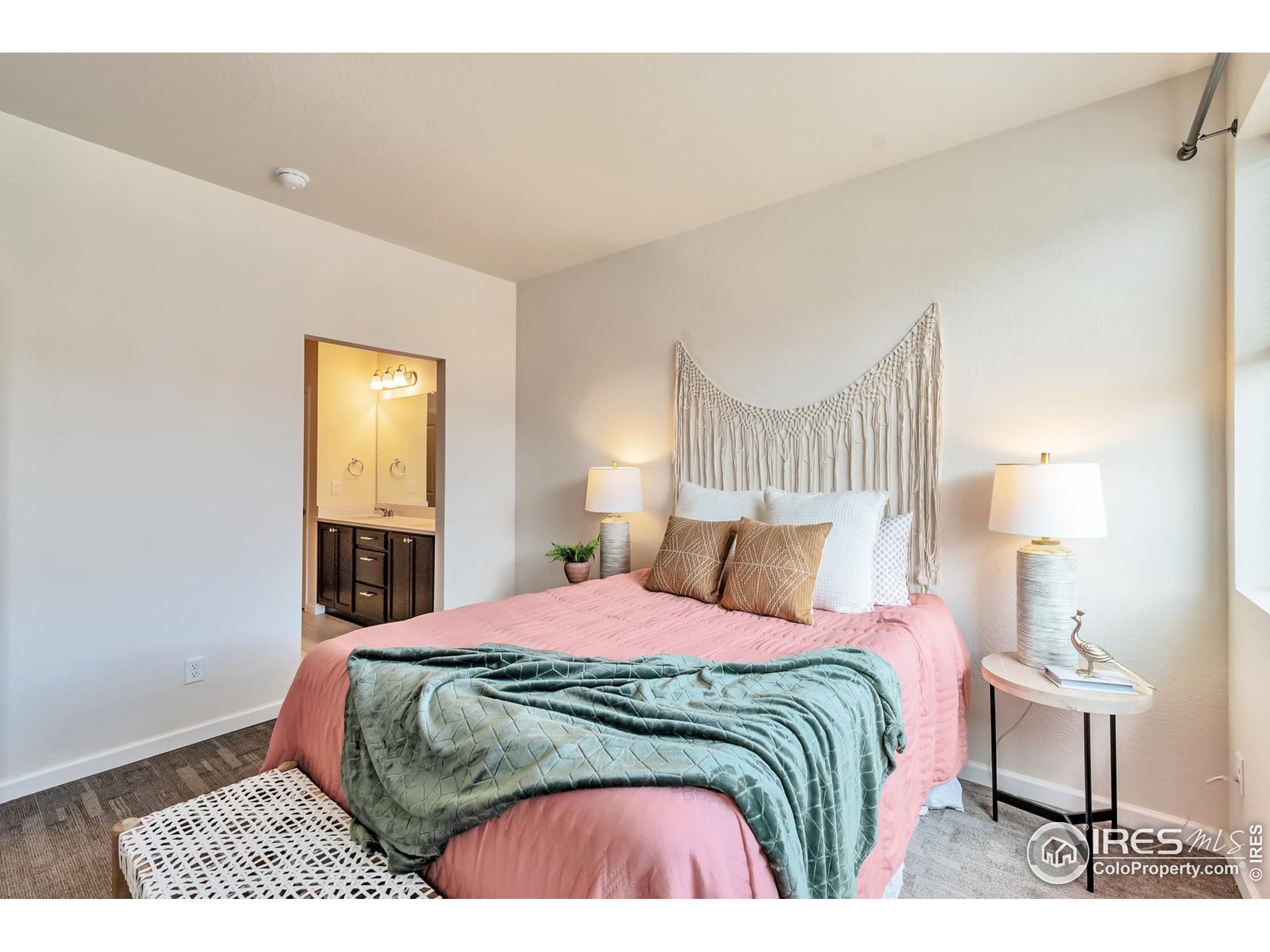 15546 West 64th Loop, Unit C Arvada, CO 80007 - Photo 15 of 27 a bedroom with a bed and a lamp