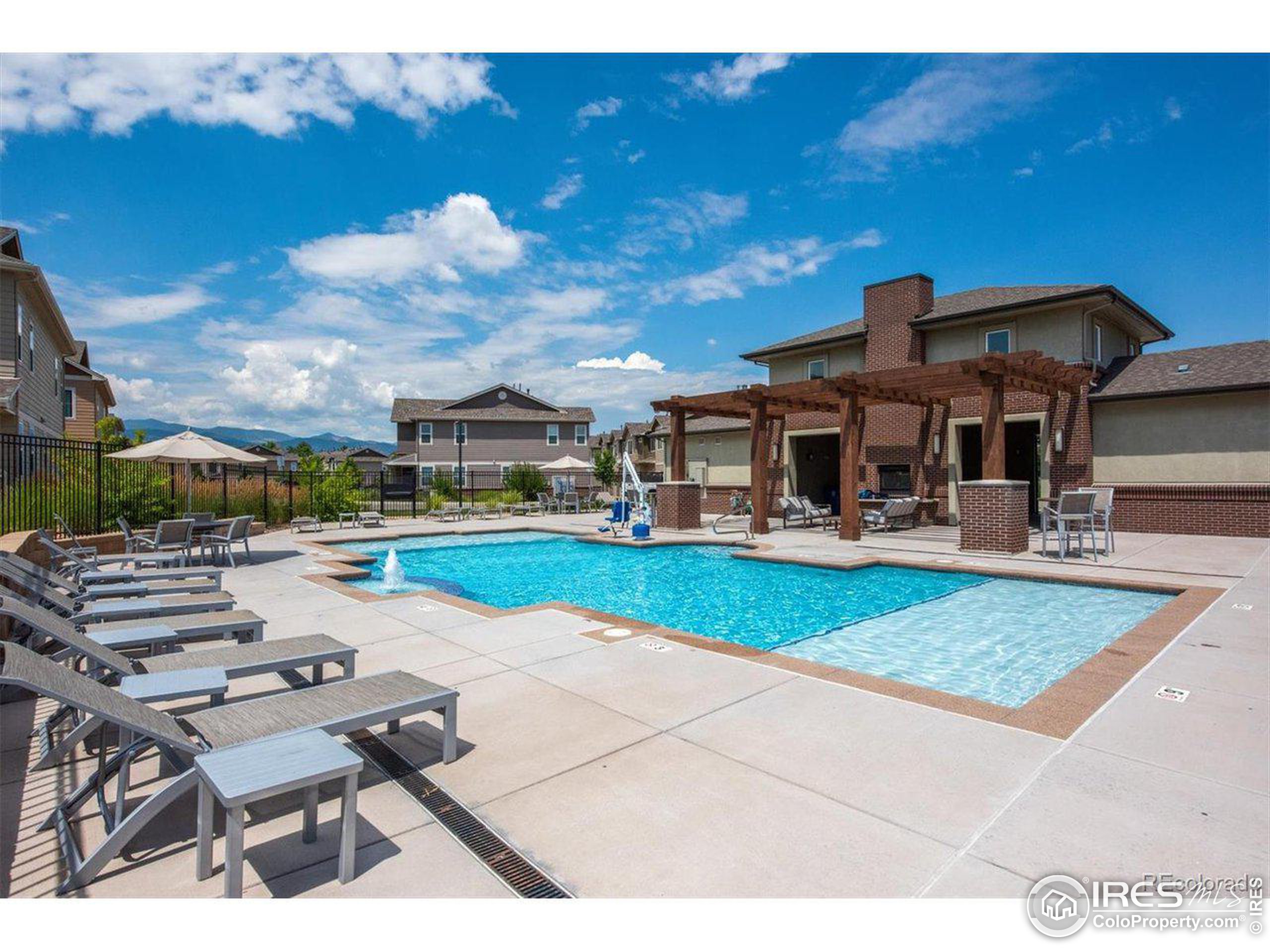 15546 West 64th Loop, Unit C Arvada, CO 80007 - Photo 25 of 27 a view of a house with swimming pool yard and sitting area