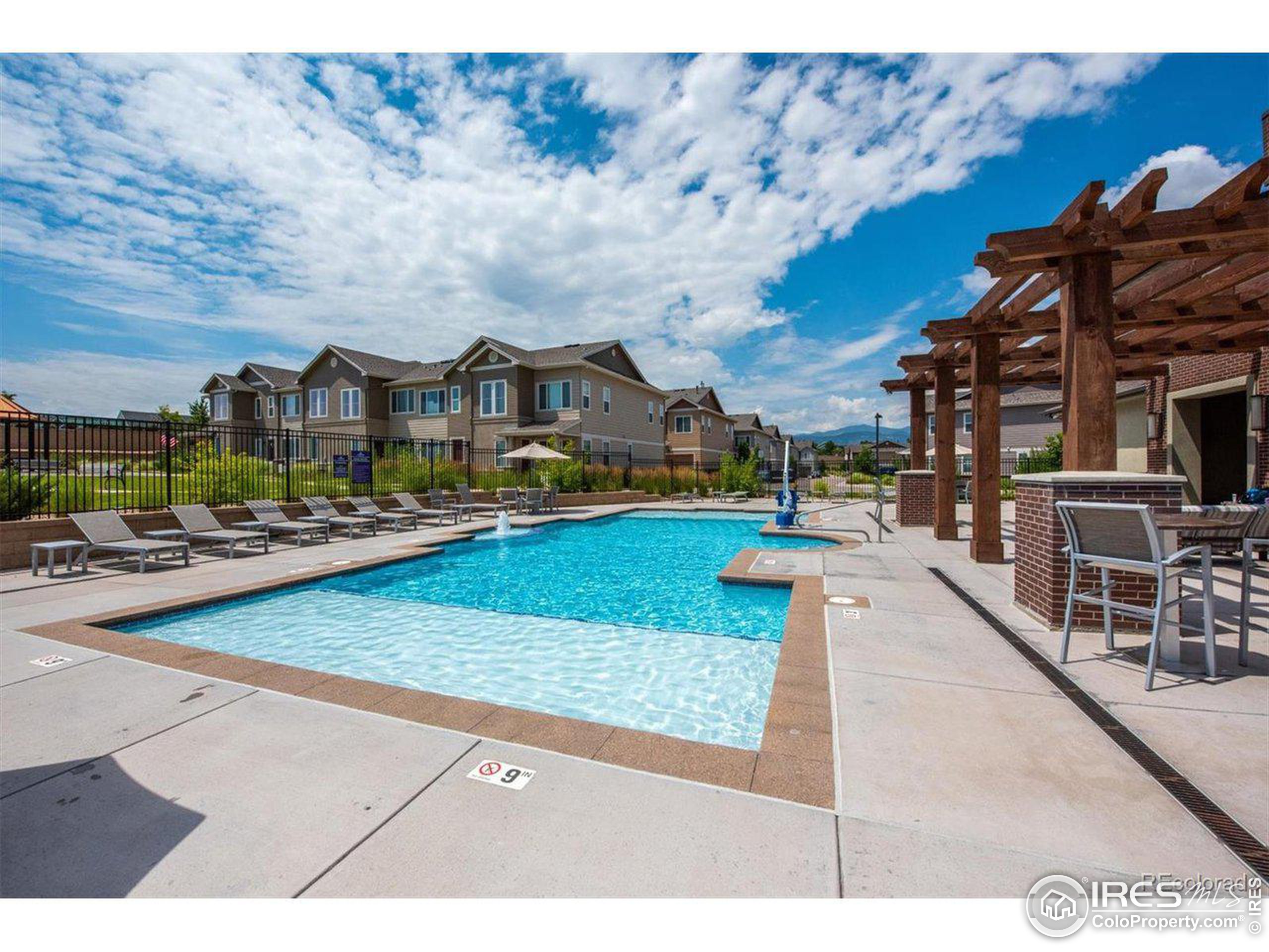15546 West 64th Loop, Unit C Arvada, CO 80007 - Photo 26 of 27 a view of multiple houses with a yard