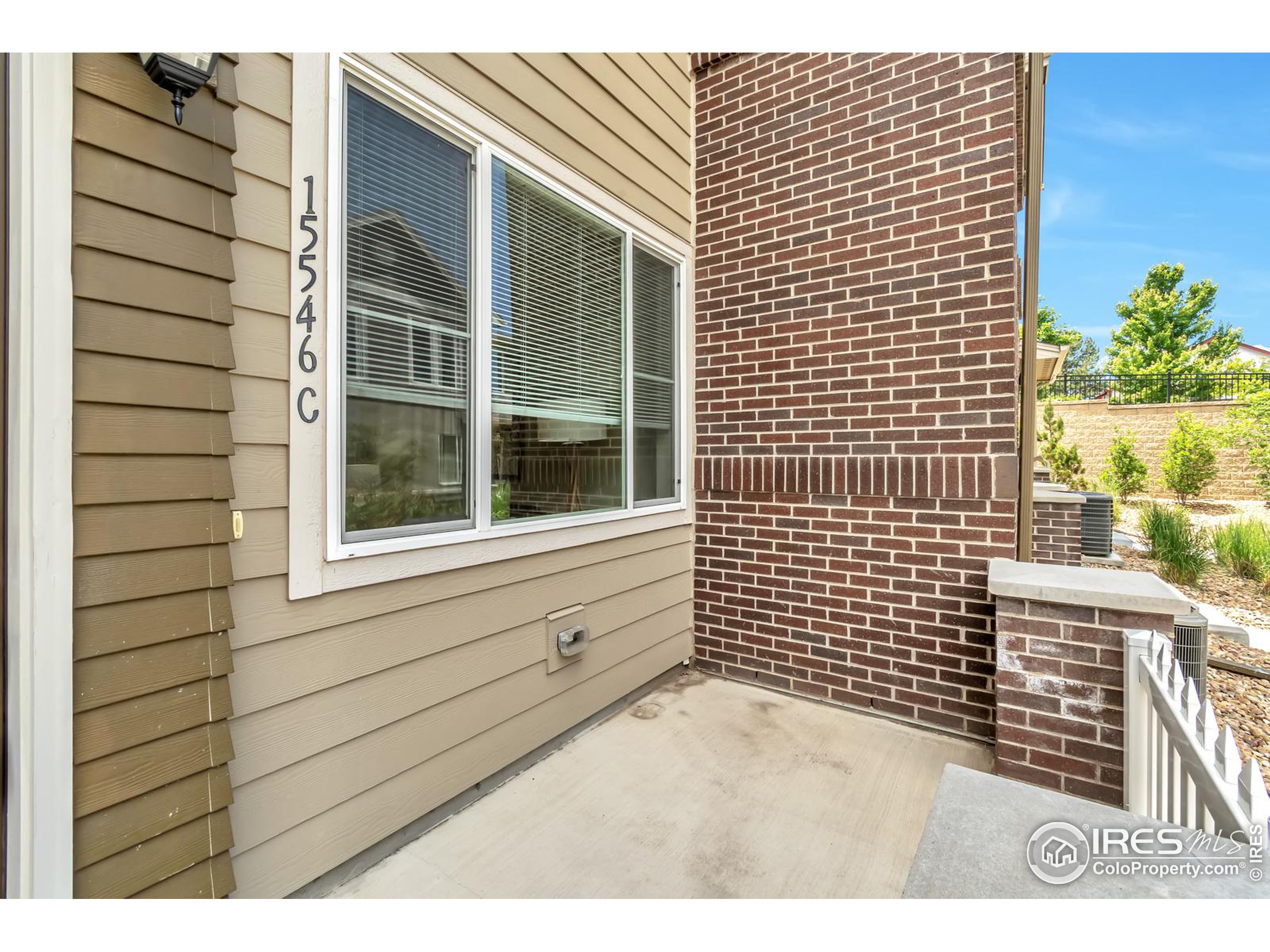 15546 West 64th Loop, Unit C Arvada, CO 80007 - Photo 3 of 27 a view of a door and a window