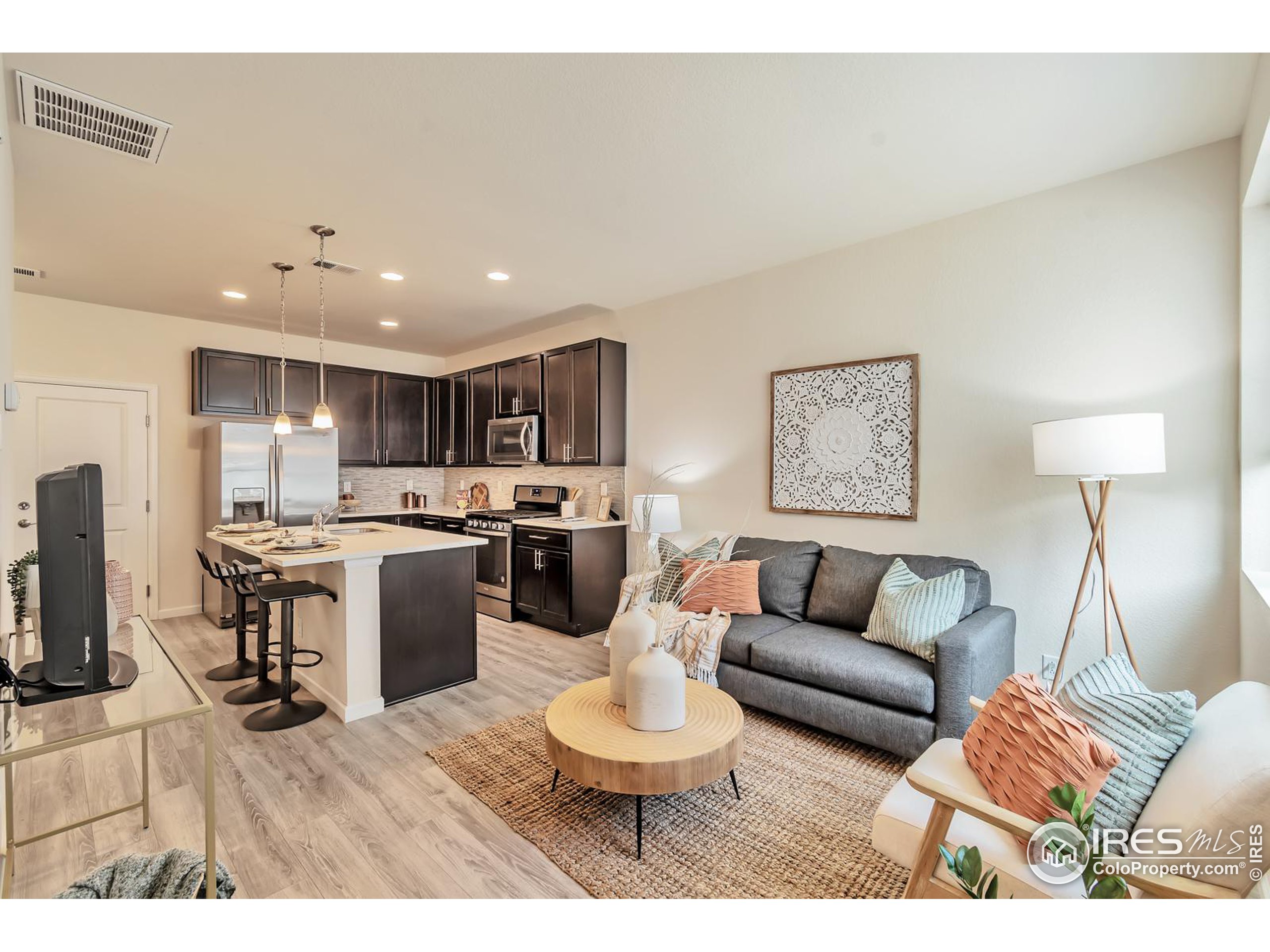 15546 West 64th Loop, Unit C Arvada, CO 80007 - Photo 4 of 27 a living room with furniture a sink and a mirror