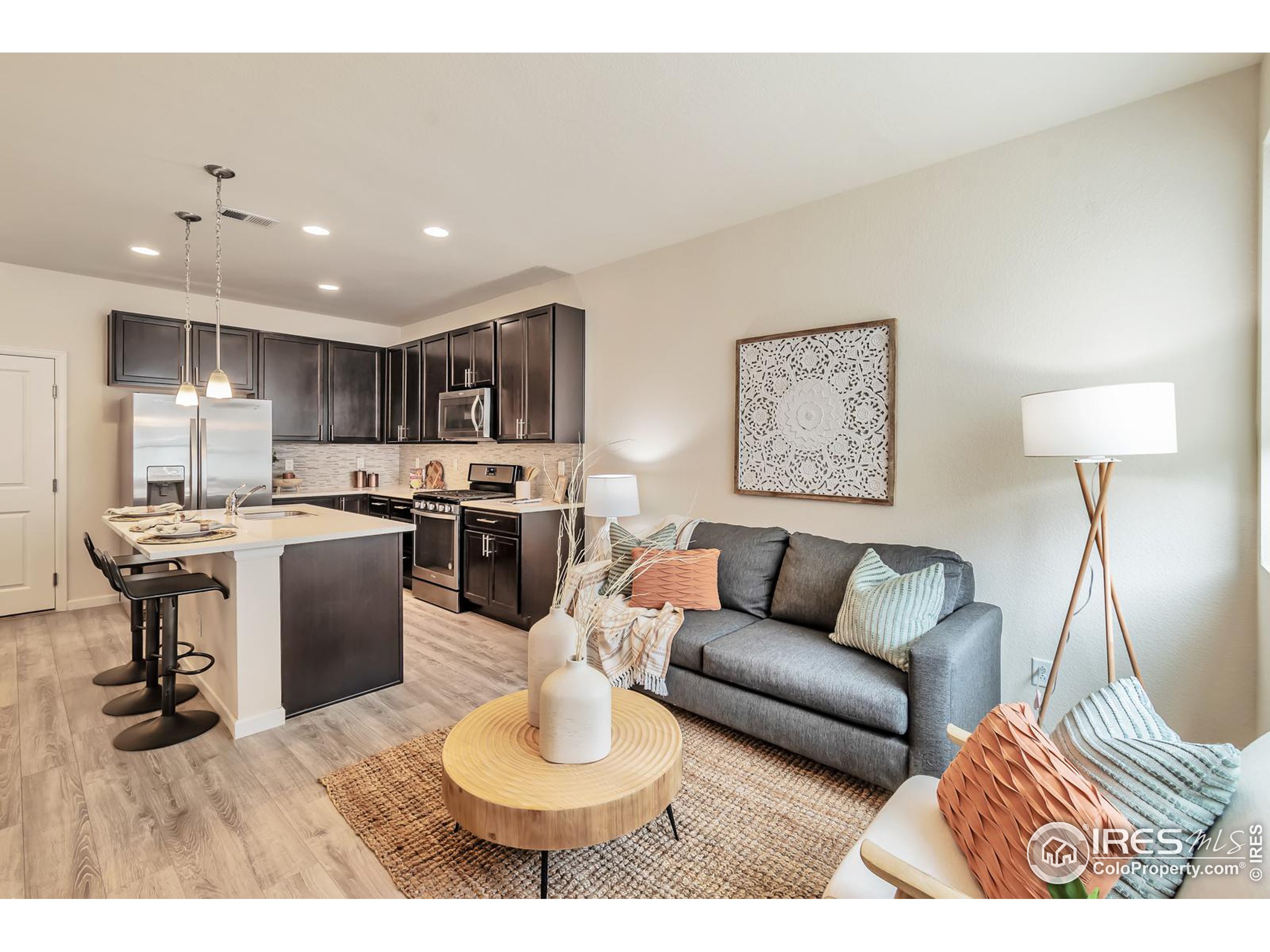 15546 West 64th Loop, Unit C Arvada, CO 80007 - Photo 5 of 27 a living room with furniture and kitchen