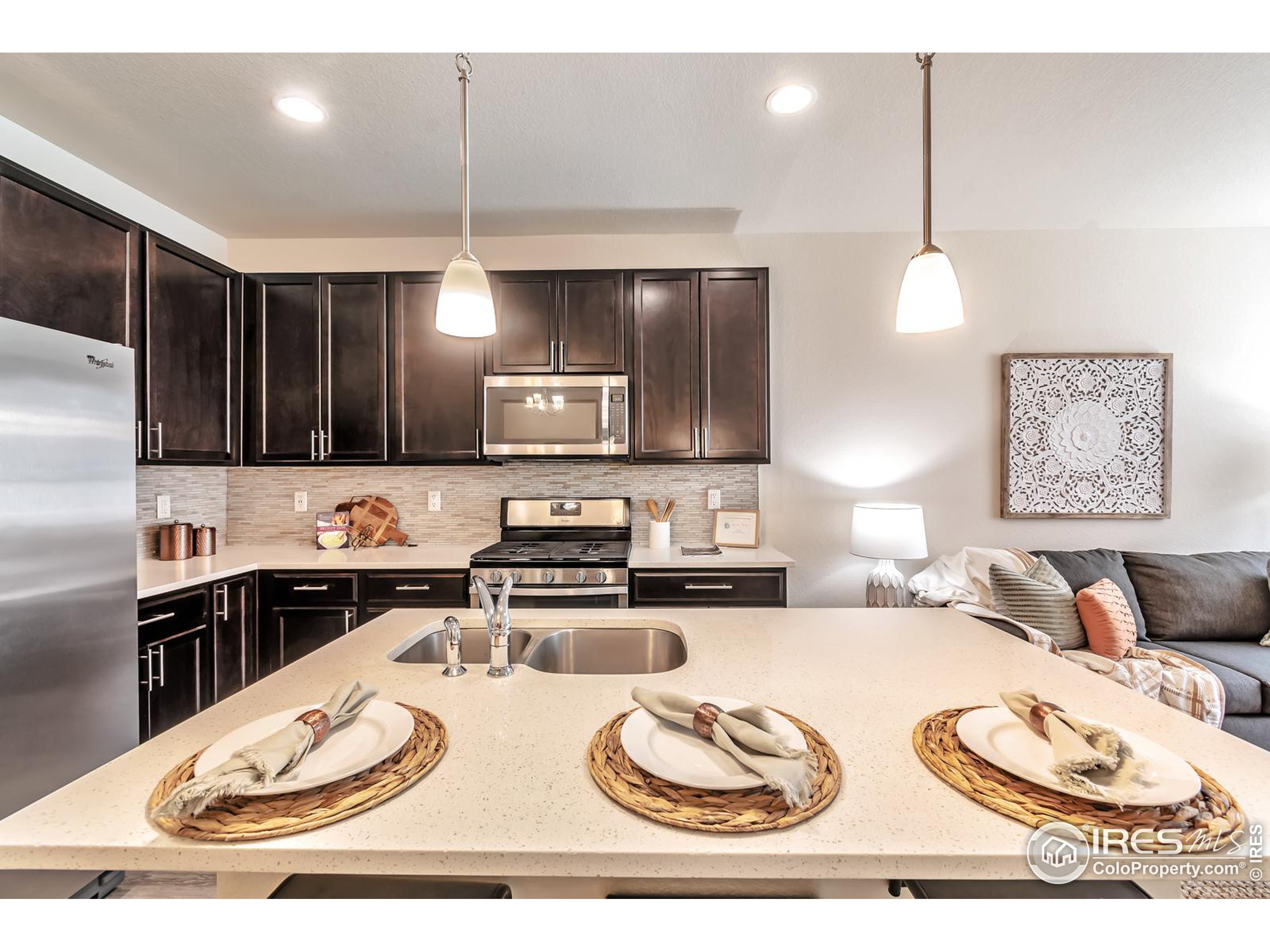 15546 West 64th Loop, Unit C Arvada, CO 80007 - Photo 9 of 27 a kitchen with a appliances wooden floor dining table and chairs