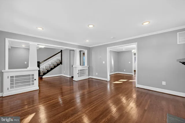 a kitchen with stainless steel appliances granite countertop a refrigerator a sink dishwasher a stove and white countertops with wooden floor