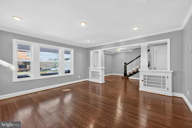 a kitchen with stainless steel appliances granite countertop a sink a stove and a wooden floor