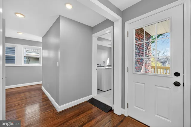 a view of wooden floor and windows in a room