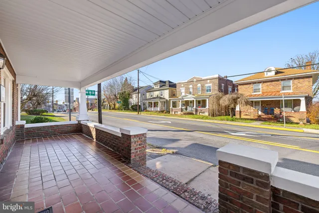 a view of empty room with wooden floor and fireplace