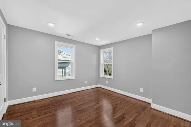 a front view of a building with a garden