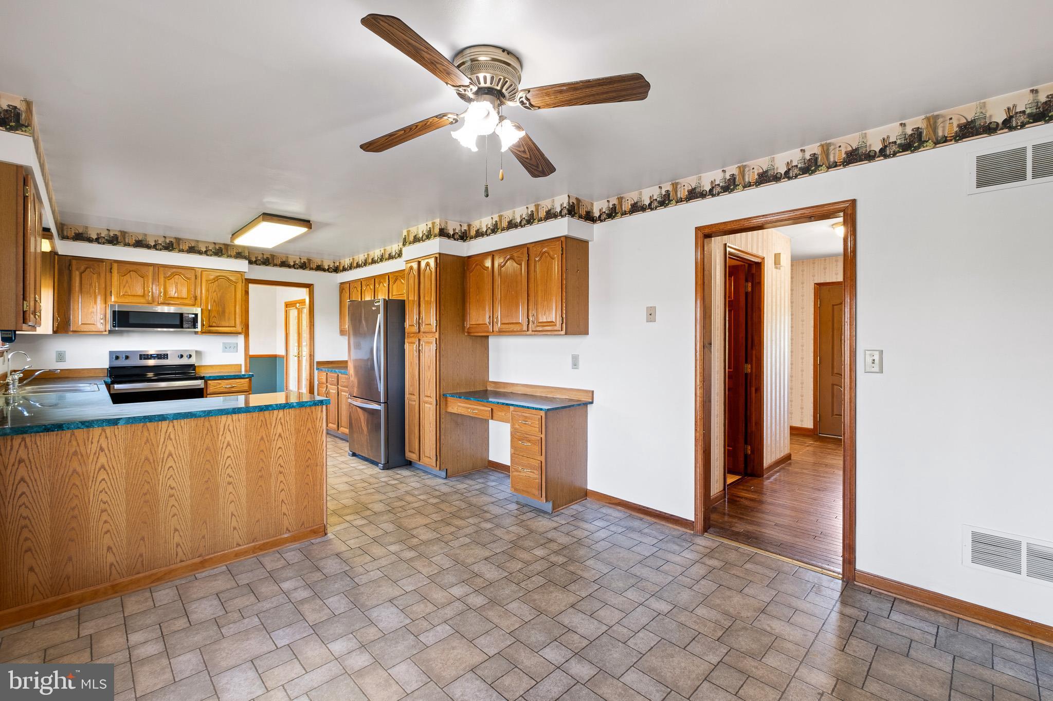 39 Long Drive Elkton, MD 21921 - Photo 17 of 39 a large kitchen with stainless steel appliances granite countertop a refrigerator and a stove top oven