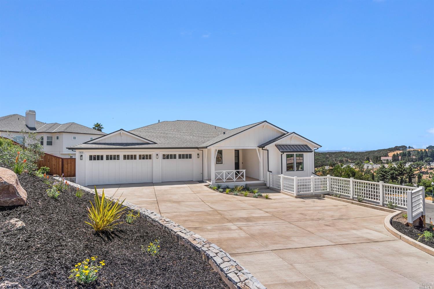 a front view of a house with a garden