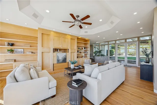 a living room with fireplace furniture and a large window