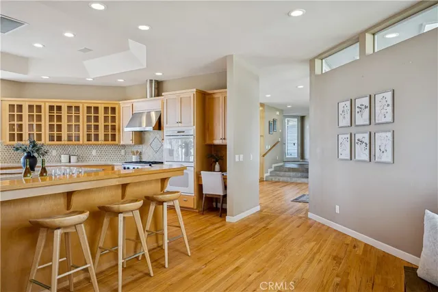 a view of a room with wooden floor and windows