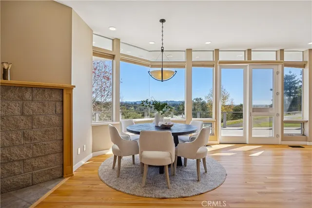 a living room with furniture a wooden floor and a large window