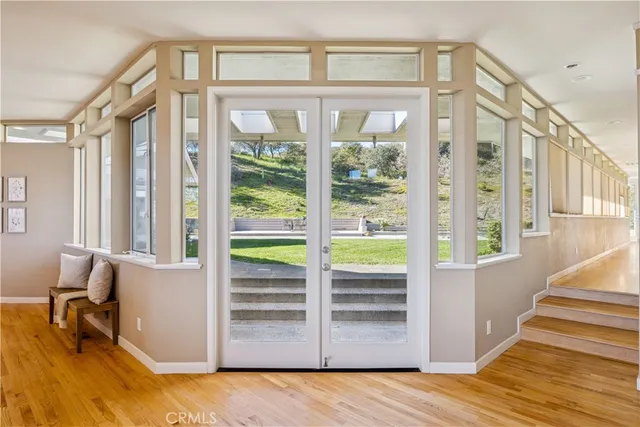 a spacious bedroom with a bed and a large window