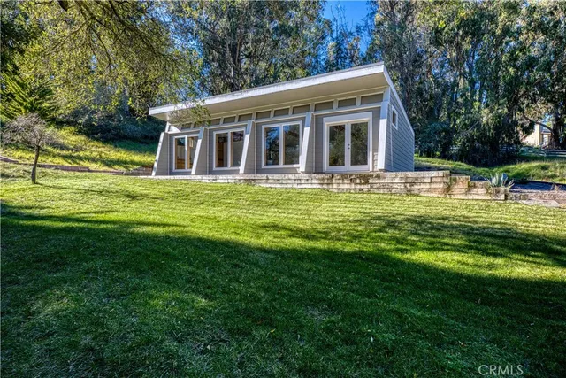 a view of house with a yard