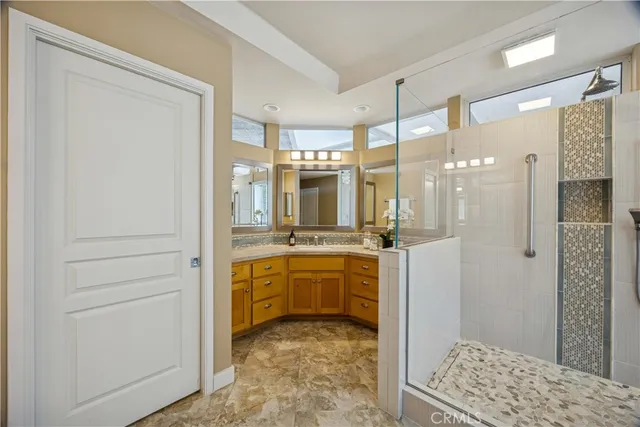 a kitchen with stainless steel appliances granite countertop a sink and a refrigerator