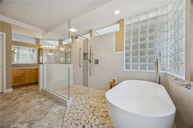 a kitchen with stainless steel appliances granite countertop a stove and a large window
