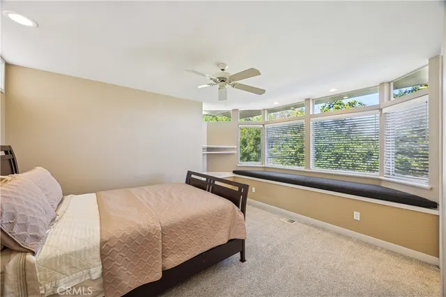 a view of a balcony with wooden floor & fence