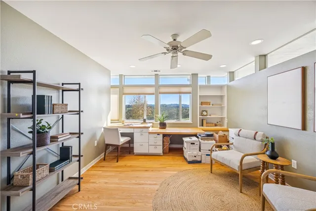a view of a balcony with wooden floor and fence