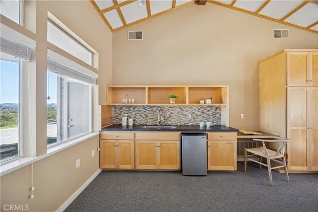 a view of house with a table and chair in patio