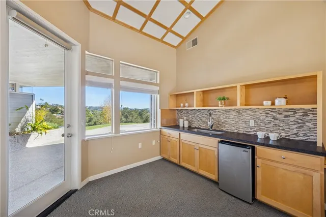 a view of a house with swimming pool and sitting area