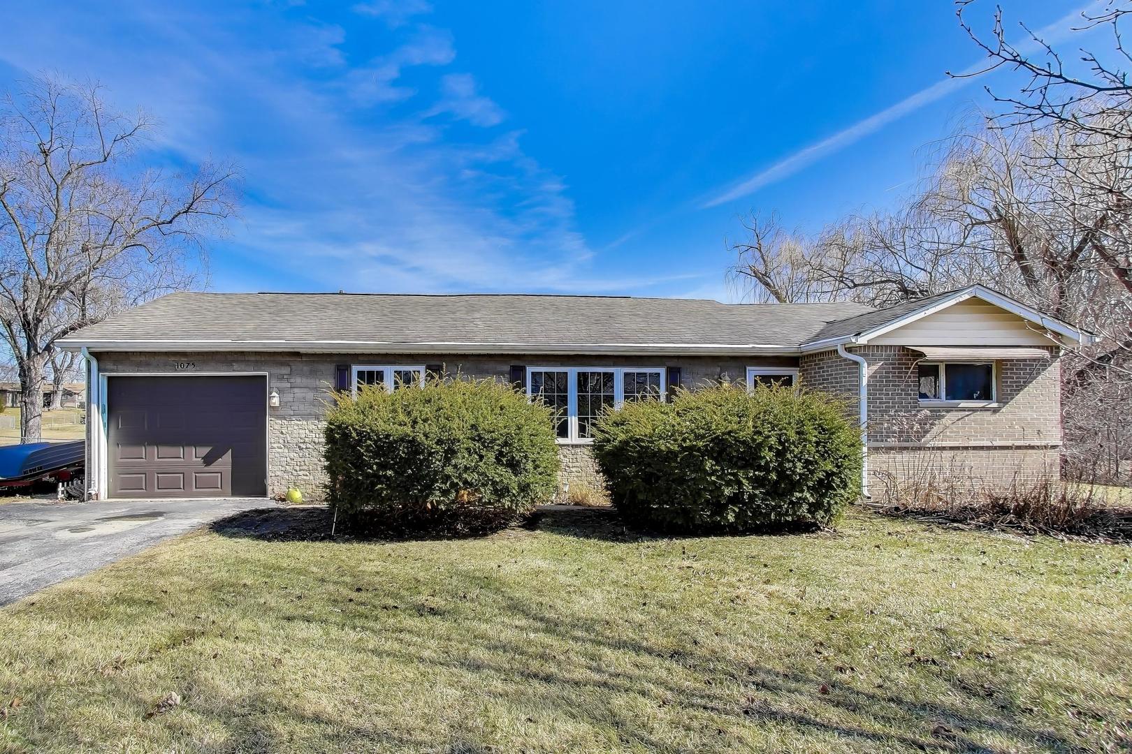 1075 Apricot Street Hoffman Estates, IL 60169 - Photo 1 of 28 a front view of a house with a garden