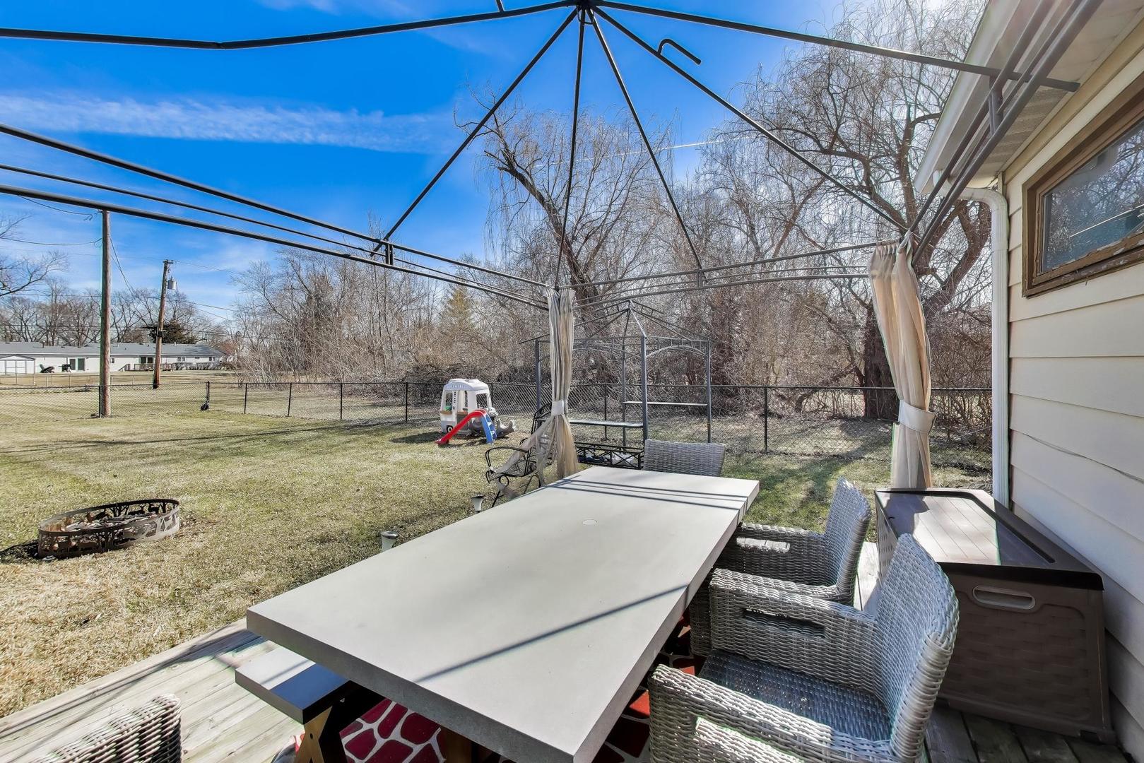 1075 Apricot Street Hoffman Estates, IL 60169 - Photo 19 of 28 a view of yard from deck with patio