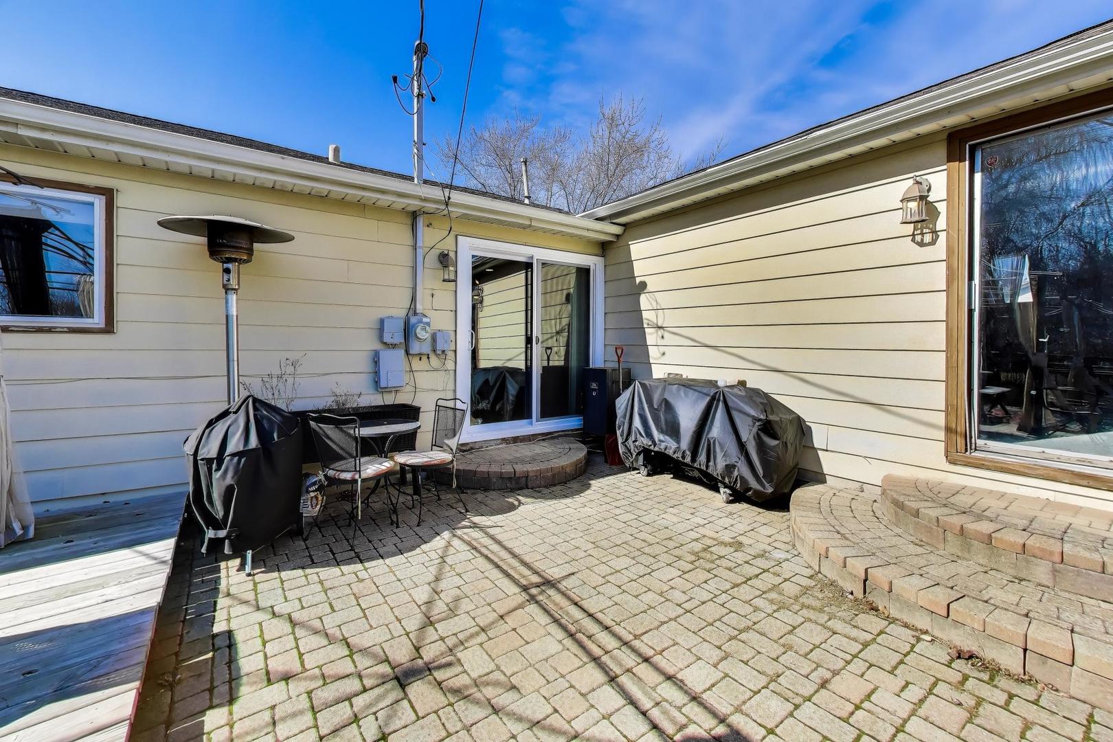 1075 Apricot Street Hoffman Estates, IL 60169 - Photo 21 of 28 a view of a patio with a table and chairs and wooden floor