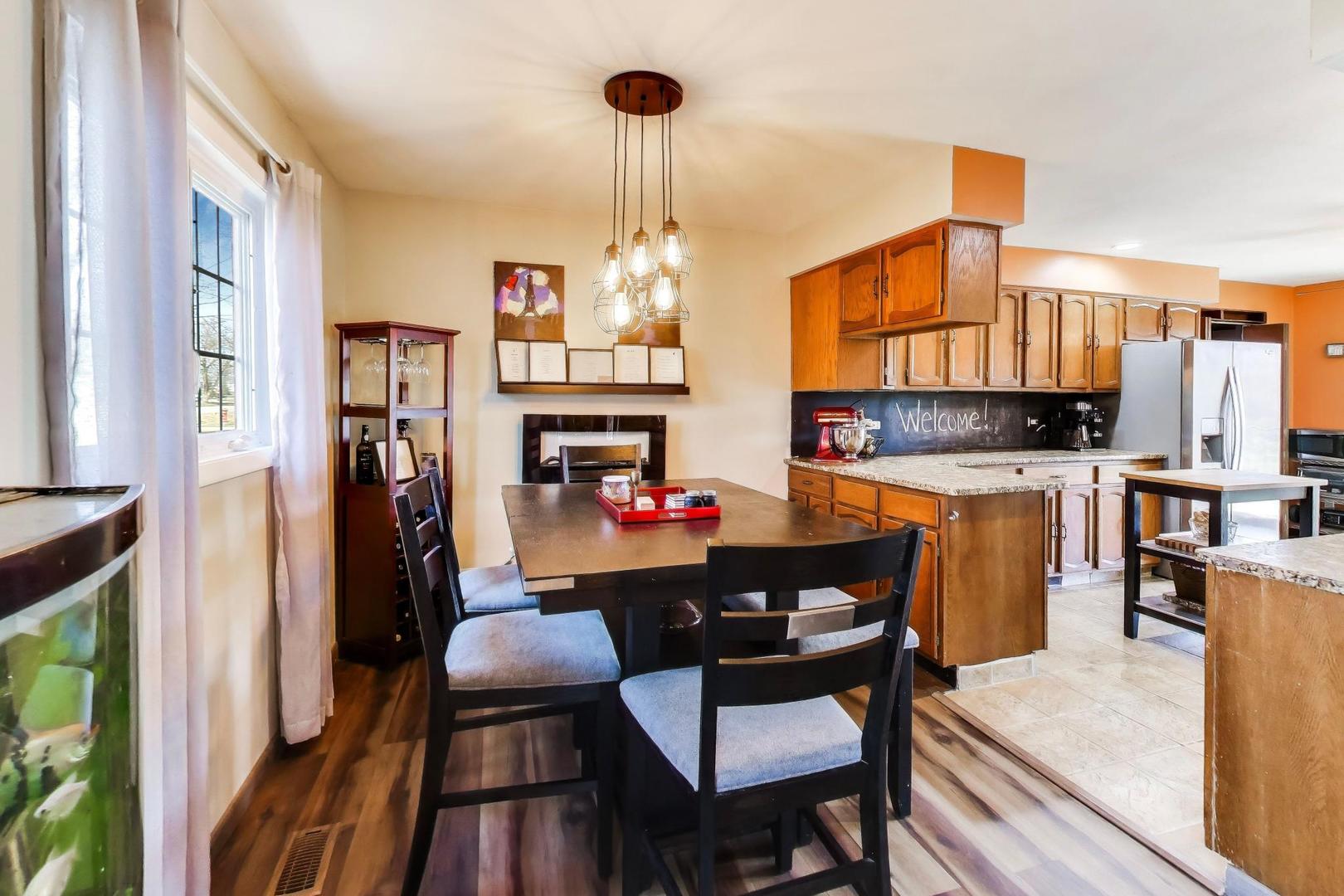 1075 Apricot Street Hoffman Estates, IL 60169 - Photo 4 of 28 a dining room with furniture and a kitchen view