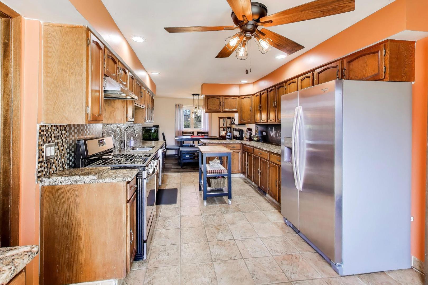 1075 Apricot Street Hoffman Estates, IL 60169 - Photo 6 of 28 a kitchen with stainless steel appliances a stove a refrigerator and a refrigerator