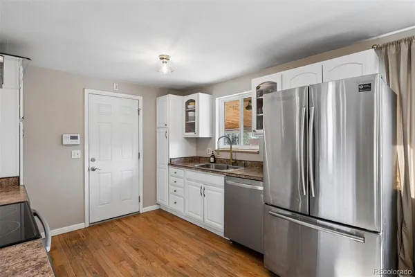 a kitchen with stainless steel appliances a refrigerator and a stove top oven