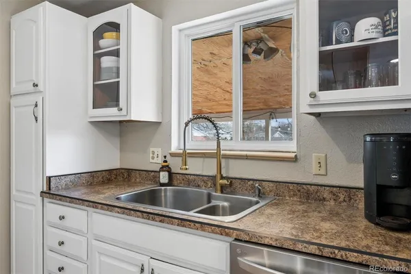 a kitchen with granite countertop a sink and a window