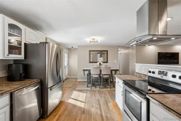 a kitchen with stainless steel appliances granite countertop a refrigerator stove and sink