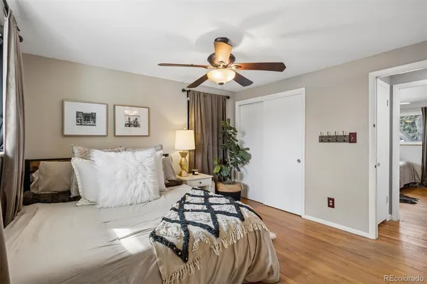 a bedroom with a bed and a chandelier