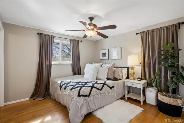 a bedroom with furniture and a large window