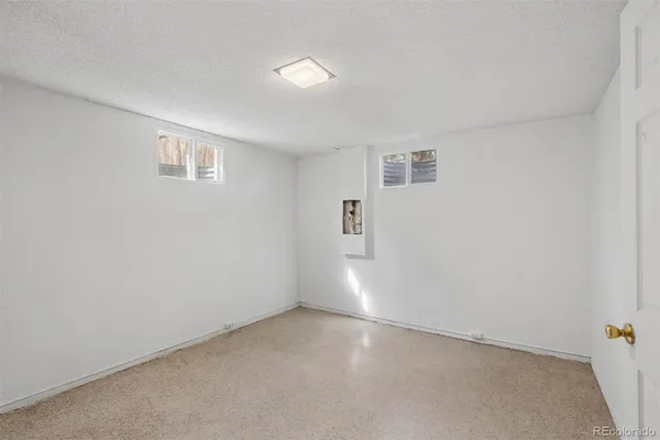 an empty room with a empty space and windows