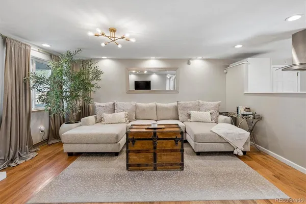 a living room with furniture and a mirror
