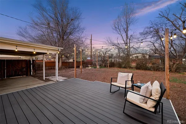 a view of backyard with table and chairs and wooden floor