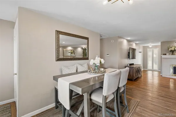 a dining room with furniture and wooden floor