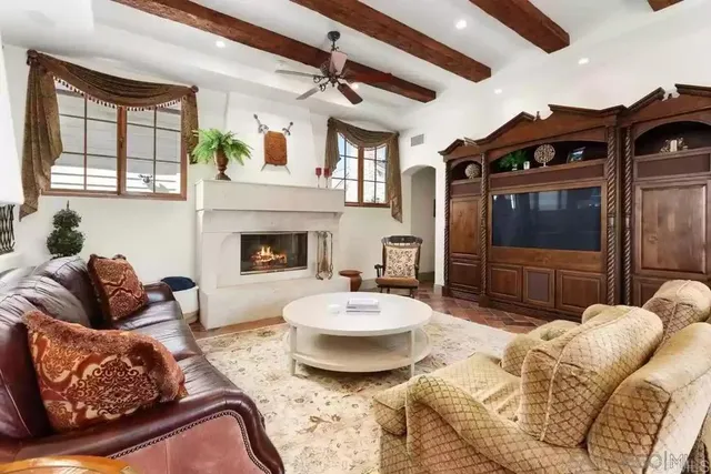 a spacious bedroom with a bed couch and a window