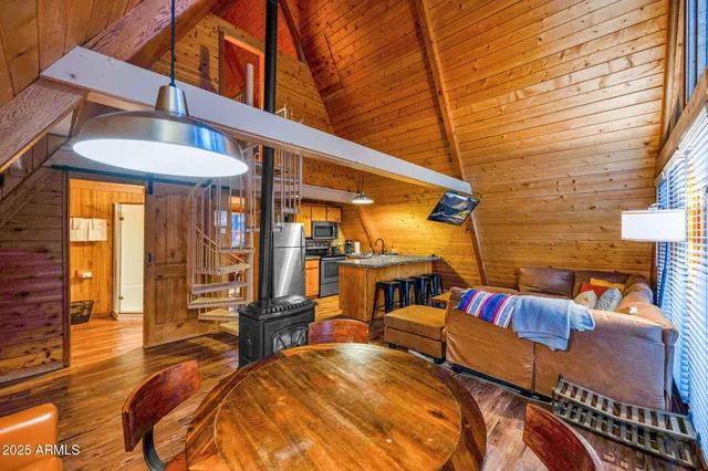 a view of a patio with table and chairs with wooden floor and fence
