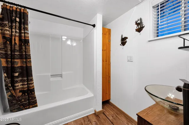 a bathroom with a bathtub and shower