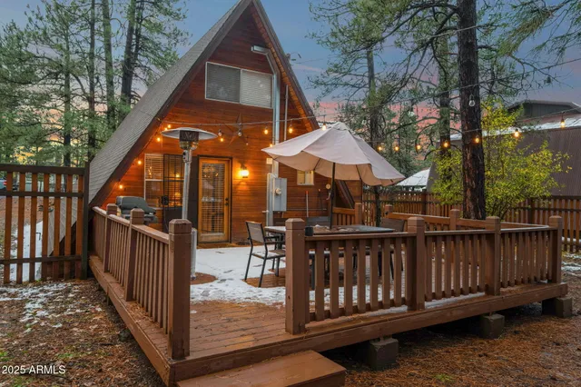 a view of a chairs and fire pit in the backyard