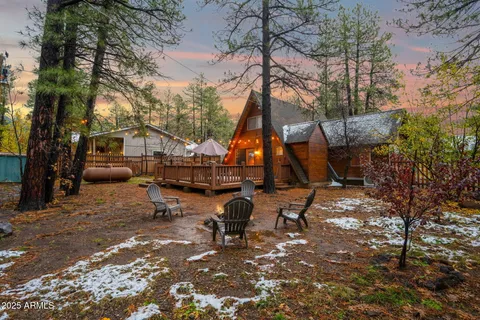 a view of a house with a yard wooden fence and a tree